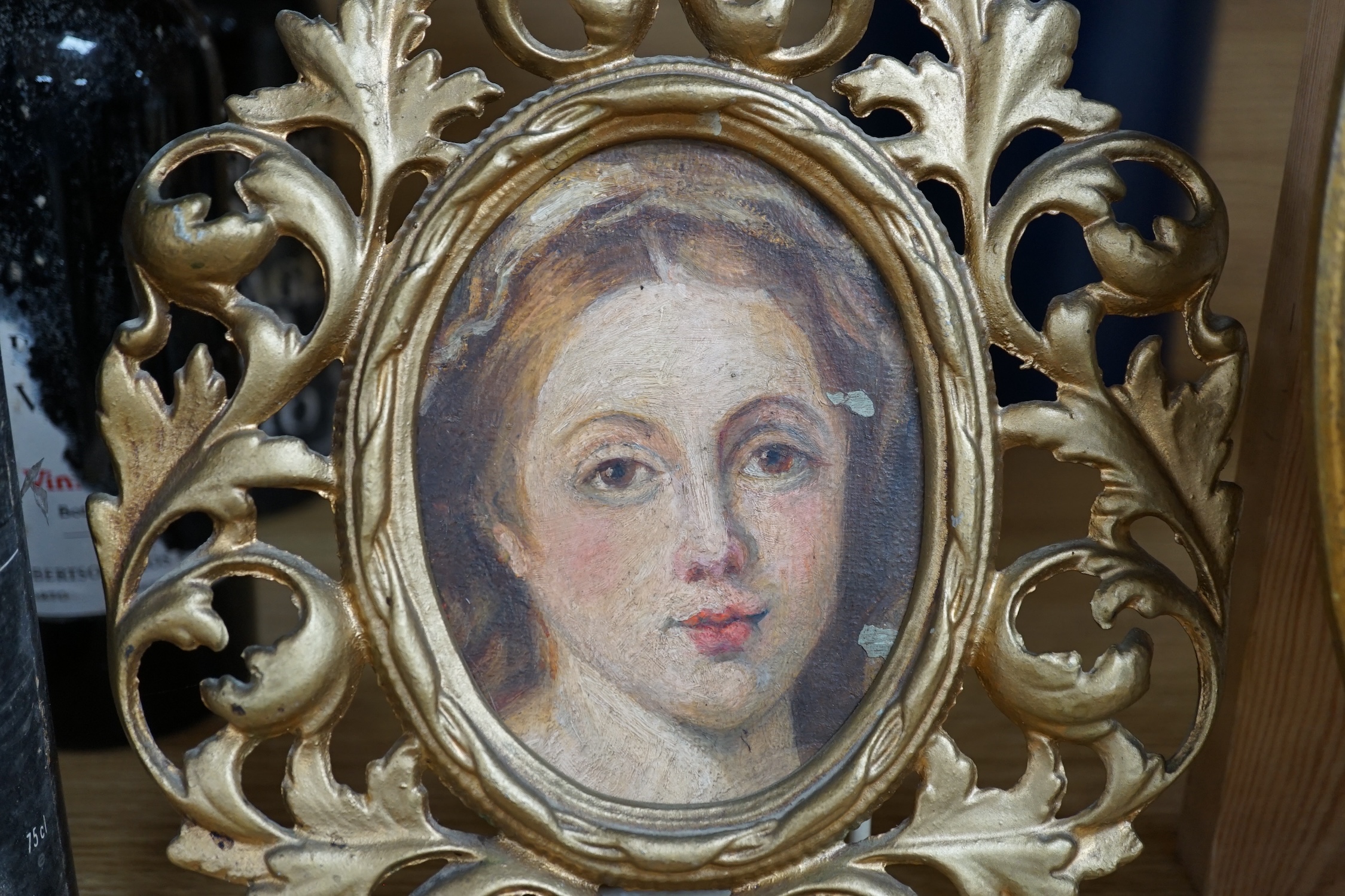 Early 19th century, oval oil on board, Portrait of a gentleman, together with another portrait of a lady, housed in a gilt metal frame, and an Italian rococo style gilt framed wall mirror, largest 28 x 22cm. Condition -